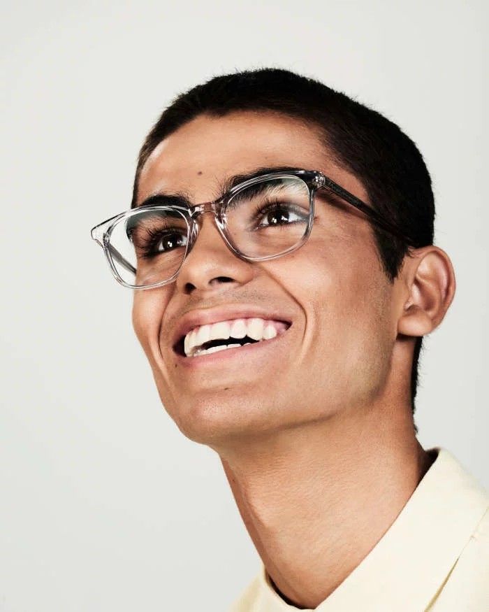 Laughing student in glasses on a light background